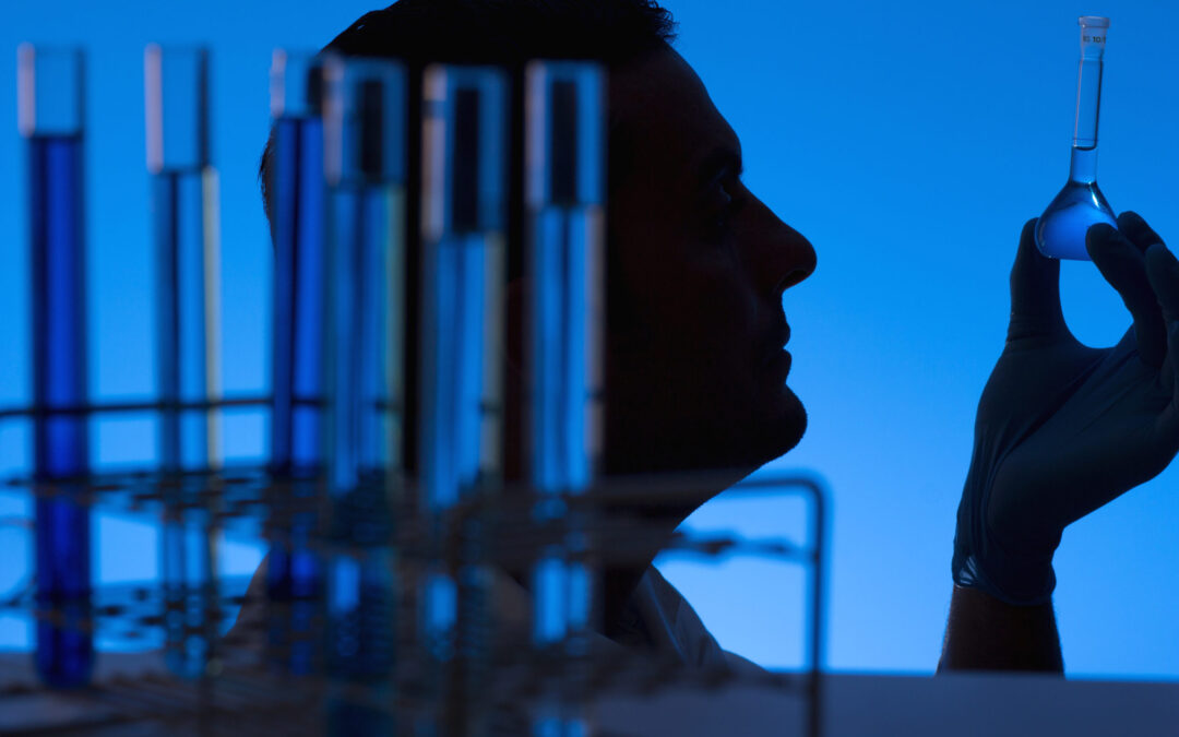 Researcher looking into a flask at the laboratory